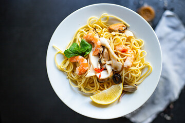 spaghetti seafood pasta shrimp, mussels, squid and more second course healthy meal snack ingredient top view copy space for text food background rustic