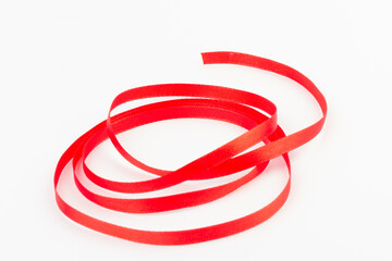 Top view of Red ribbon isolated shiny rolled on white background. Flat lay view.