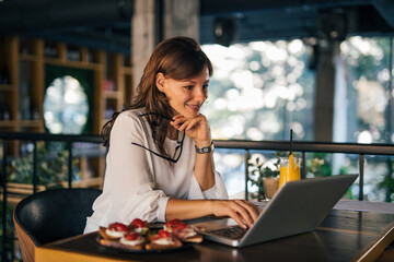 Working online, at restaurant.