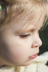 Close up portrait of cute three years old blonde girl.