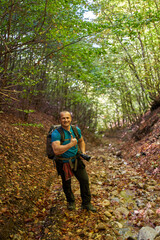 Nature photographer hiking into the forest