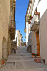 Fototapeta premium A narrow street among the old houses of San Giorgio la Molara, a rural village in the Campania region, Italy.