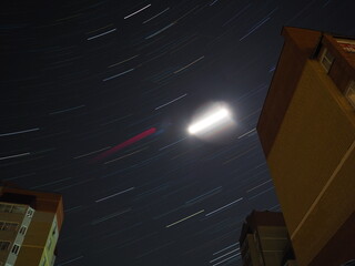 The star trail between the houses