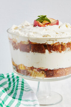 Trifle dessert with whipped cream and peaches