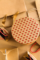 Valentine's Day concept. Shopping paper bags and round gift box with hearts print background. 