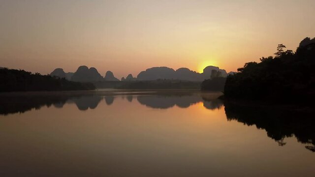 Beautiful Reflection Of Hills And Islands In Nong Thale Lake Thailand In Sunrise - Moving wide shot