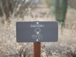 Warning sign for rattlesnakes in desert
