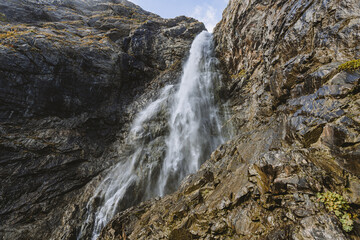 Waterfall in mountain. Hiking and ecotourism in Caucasus mountain.