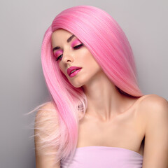 Beauty Fashion woman with Colorful Pink Dyed Hair. Girl with blue eyes, perfect Makeup and Hairstyle. Beautiful smiling model portrait, fashionable pink make up, hair. Skincare concept