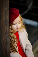 Cute girl in red beret on a walk in the fall