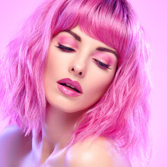 Fototapeta premium Beauty Fashion woman with Colorful Pink Dyed Hair. Girl with blue eyes, perfect Makeup and Hairstyle. Beautiful smiling model portrait, fashionable pink make up, hair. Skincare concept