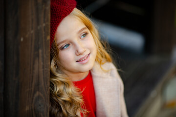 Cute girl in red beret on a walk in the fall