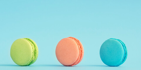 Almond macaroon  on blue background , with copy space banner.