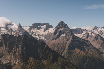 Panoramic view of mountain peaks. Summer in mountains. Hiking and ecotourism in mountain. 