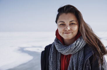 Young adult woman outdoors in icy landscape