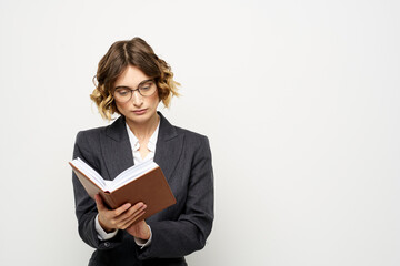 business woman in a suit with documents in hands light background curly hair hairstyle