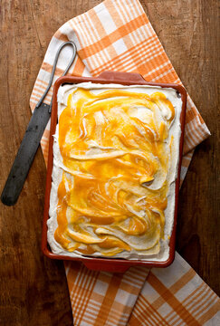 Overhead view of mango tres leches cake served on table
