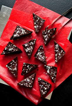 Overhead view of shortbread ganache bars served on red paper