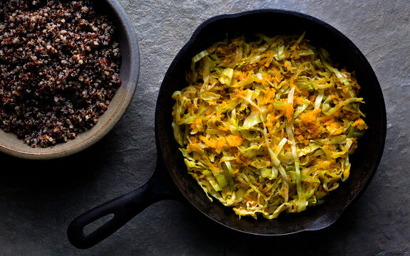 Sauteed shredded winter squash and cabbage with winter vegetable gratin on table