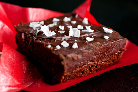 Close up of shortbread ganache bar on red paper