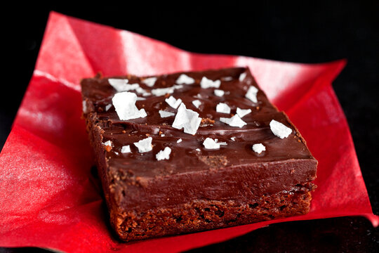 Close up of shortbread ganache bar on red paper
