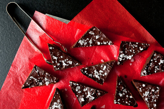 Overhead view of shortbread ganache bars served on red paper