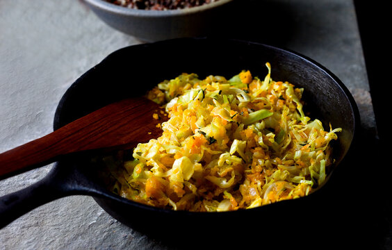 Close up of sauteed shredded winter squash and cabbage in frying pan