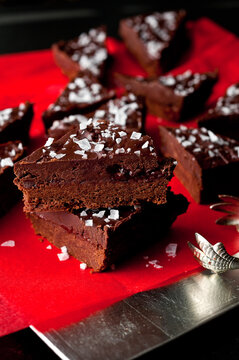 Close up of shortbread ganache bars served on red paper