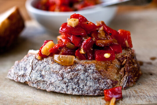 Close Up Of Roasted Pepper Sauce On Slice Of  Bread Served On Table