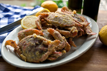 Close up of fried soft shell crab with cornmeal coating served on plate