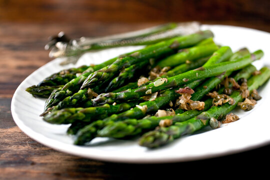 Close up of asparagus with anchovies and capers served on plate