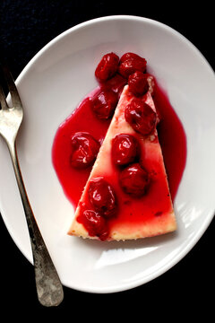 Overhead view of creme fraiche cheesecake with sour cherries served on plate