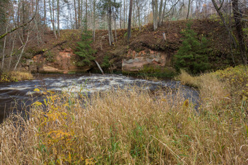 City Cesis, Latvia. Rapid river with stones and trees. Natural flora.Travel photo.