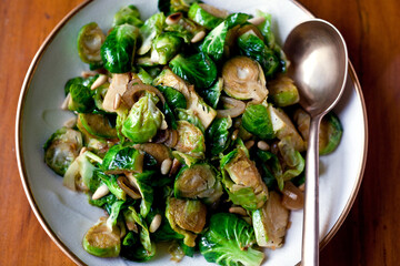 Overhead view of stir fried brussels sprouts with shallots and sherry served on plate