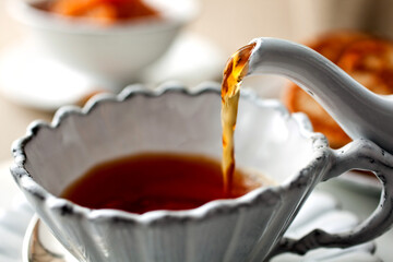 Close up of tea pouring in tea cup
