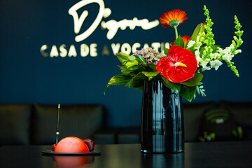 Working table with vase of flowers in modern office. Bouquet of flowers on a table in a modern room.