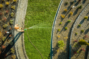 Garden Worker Watering Newly Installed Natural Grass