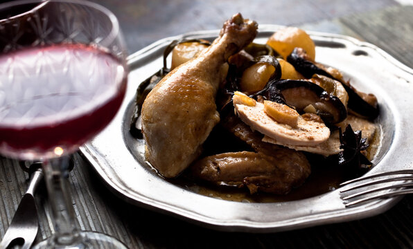 Sesame braised chicken served with red wine on table
