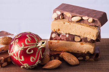 Almond nougat, typical Christmas dessert on wooden background