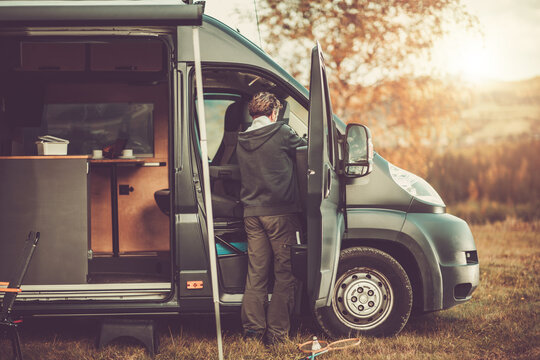 Men with RV Camper Van on a Camping