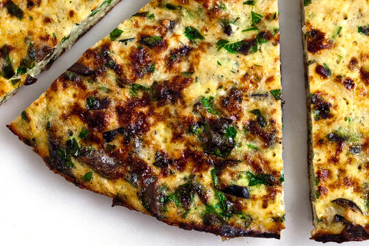 Close up of frittata with turnips and olives