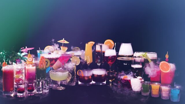 Many various colorful cocktails in different glasses on black background. Many popular drinks with dry ice smoke effect. Cocktails in bar or night club, celebration time or bartender show. 