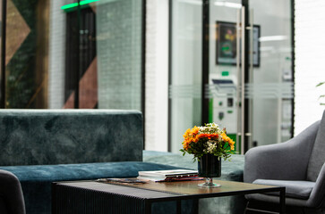 Working table with vase of flowers in modern office. Bouquet of flowers on a table in a modern room.