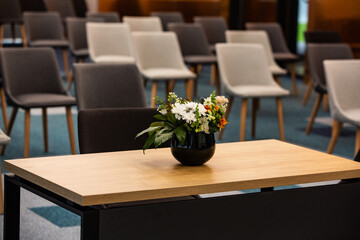Working table with vase of flowers in modern office. Bouquet of flowers on a table in a modern room.