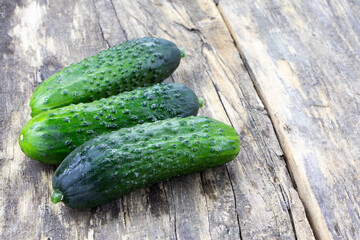 Cucumbers on a wooden background. Vegetables on a old wooden table. Healthy food. Vegan food