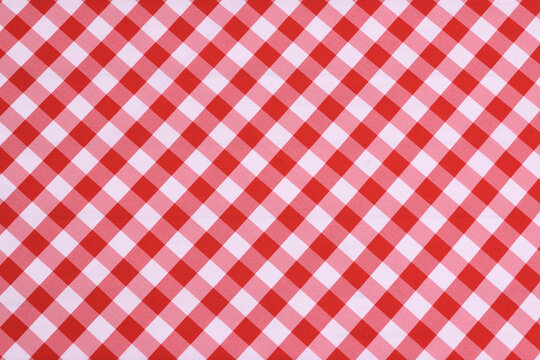 Red checkered textile picnic tablecloth pattern in close-up. Classic italian cuisine style.