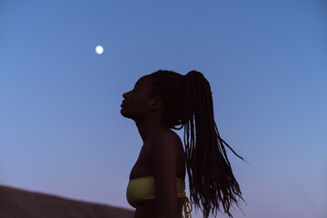 African woman and the moon