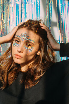 Attractive girl with crystals decoration on her face