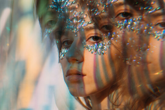 Colorful light lines on face of beautiful girl
