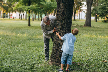 grandfather with his grandson in public park